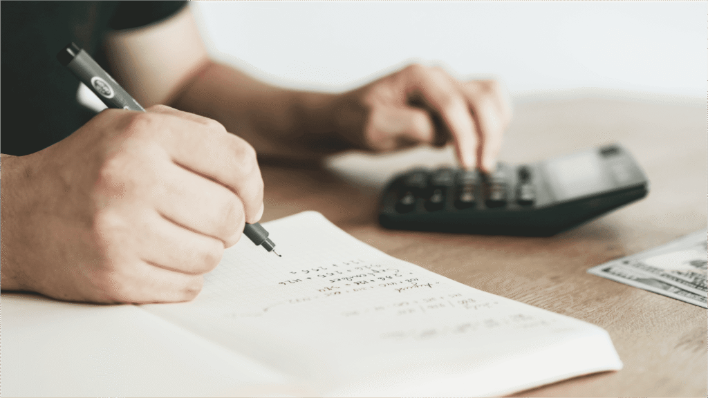 person using calculator for will estate executor