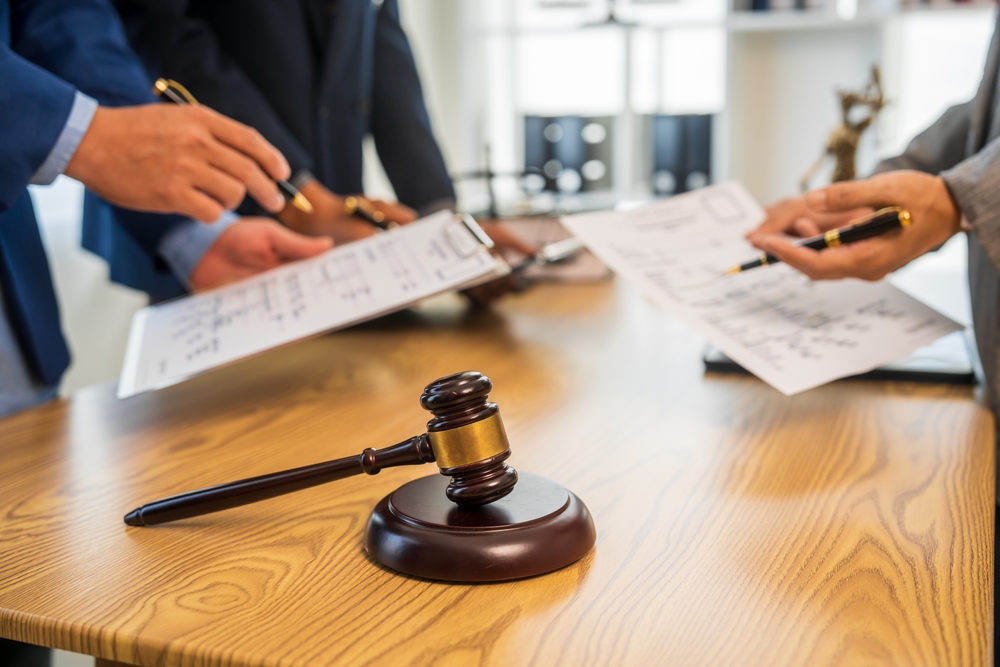 Attorneys reviewing estate documents and legal paperwork during a summary probate case in San Diego