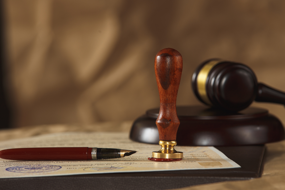 Fallbrook probate lawyer reviewing estate documents with court seal and gavel